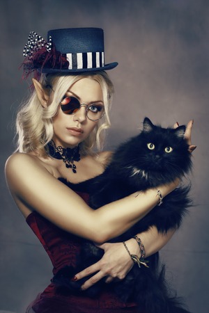 steampunk fairy tale elf girl hoding black catの写真素材