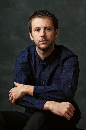 low key portait of handsome young man looking serious