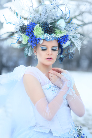 Winter Fairy or Snow queen - woman in light blue tulle dress outdoor wear floral crownの写真素材