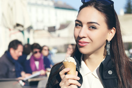 beautiful brunette woman holds ice-cream