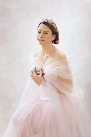 Portrait of beautiful elegant lady pink tiara and necklaceの写真素材