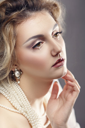 Portrait of young elegant woman wearing pearl jewelryの写真素材