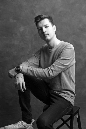black and white portrait of young man in studio