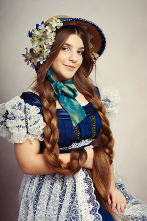 Beautiful yung teenage girl in regency era costume with very extra long hairの写真素材