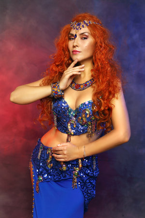 Bellydancer in action blue bra costume red hair beautiful performerの写真素材