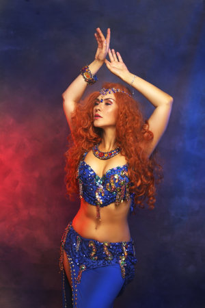 Bellydancer in action blue bra costume red hair beautiful performerの写真素材