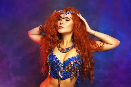 Bellydancer in action blue bra costume red hair beautiful performerの写真素材