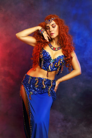 Bellydancer in action blue bra costume red hair beautiful performerの写真素材