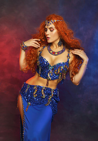 Bellydancer in action blue bra costume red hair beautiful performerの写真素材