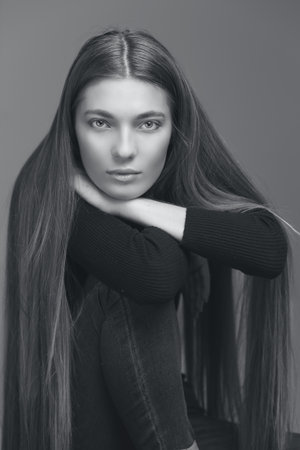 studio portrait of the beautiful young woman with long hair monochrome black and whiteの写真素材