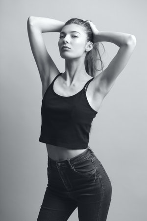Slim and Sensual: Testing the Perfection of Modern Fashion with a Beautiful Young Model in Monochrome Studio Shotsの写真素材