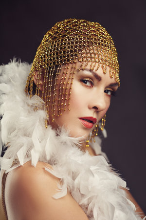 flapper woman from roaring 20s retro vintage style with golden headpiece twentiesの写真素材