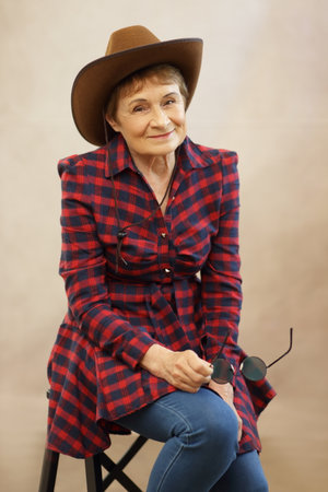 pretty woman wearing cowboy hat cowgirl in her 70sの写真素材