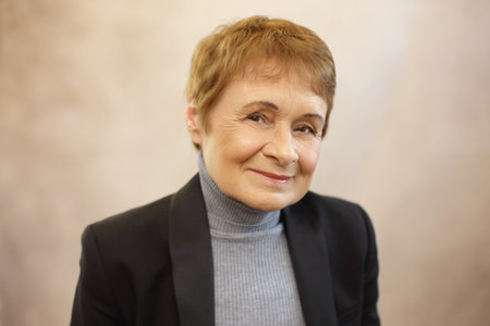 Headshot of teacher or business person beautiful woman in her 70+の写真素材
