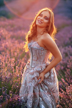 beautiful woman in evening gown on lavender fieldの写真素材