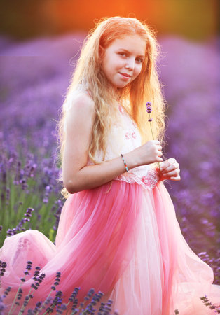 Beautifl little girl in pink dress enjoy summer lavender fieldの写真素材