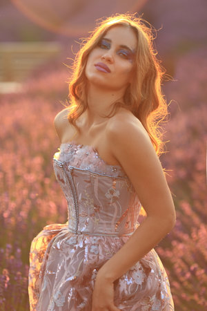 natural unretouched image of woman on sunset sunlight lavender field summerの写真素材