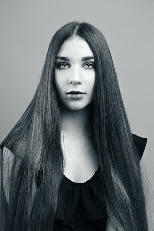 duo toned photograph of a young woman with long straight dark hairの写真素材