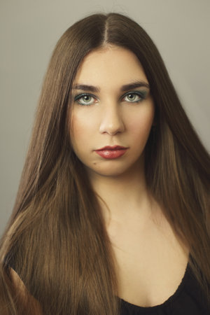 beautiful young woman portrait long dark hair calm faceの写真素材