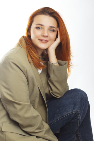 business headshot of a young beautiful women in olive jacketの写真素材