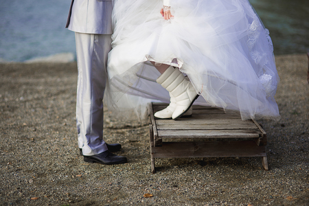 newlyweds stand in dirty footwear on boardsの写真素材