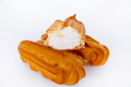 eclairs with cream on a white background isolate