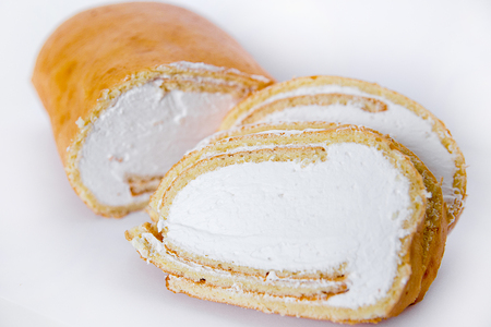 three mini rolls with cream lie on a white background isolateの写真素材