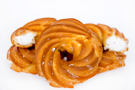 the ring from custard paste with cream lies on a white background isolate