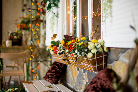 autumn scenery indoors. An arch with dry leaves, pumpkins, a mountain ashの写真素材