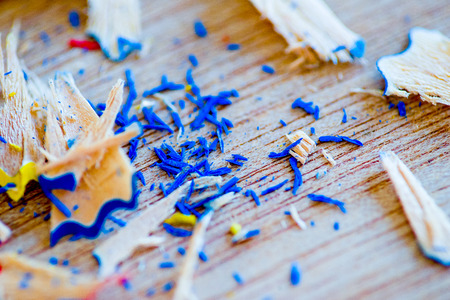 colored sawdust from pencils close-up on a wooden boardの写真素材