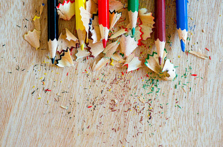 colored pencils close-up with the chips on a wooden boardの写真素材