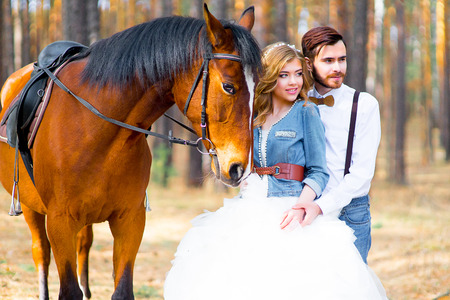 Couple posing on a horseの写真素材