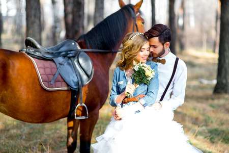 Couple posing on a horseの写真素材