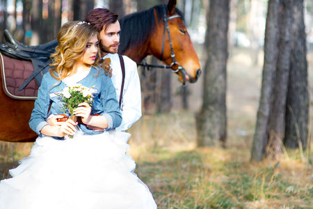wedding, country-style glamor in the forest. ?ouple posing on a horseの写真素材