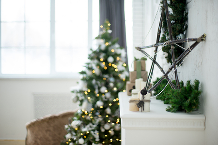 Design room with Christmas tree, sofa and the fireplace. Interior eco style bokehの写真素材