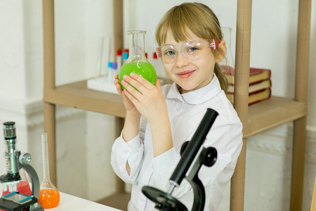 young girl making science experiments in laboratory. educationの写真素材