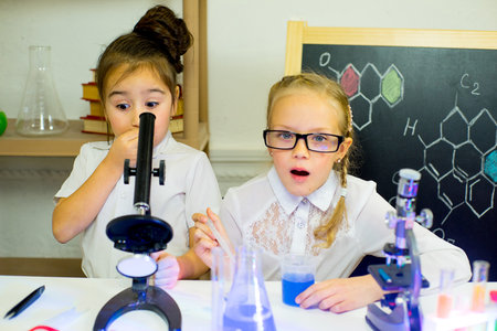 kids making science experiments in laboratory. education