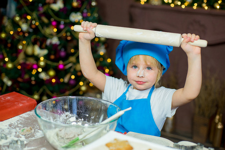 kids baking christmas cookies before the celebration of Christmas. Familyの写真素材
