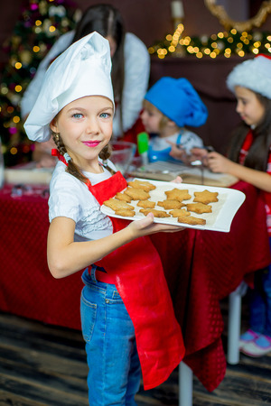 kids baking christmas cookies before the celebration of Christmas. Familyの写真素材