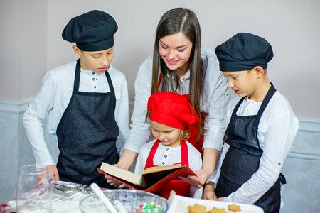 kids baking christmas cookies before the celebration of Christmas. Familyの写真素材