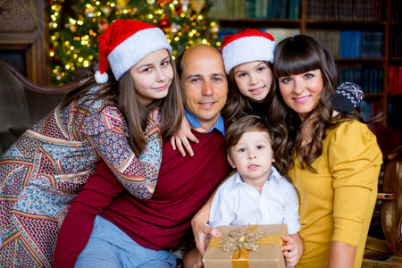 Christmas family of five people, happy parents and their kids with gifts. Christmas and New Year...