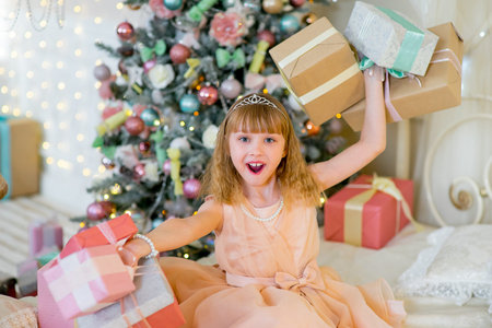 Adorable blonde girl with Christmas giftsの写真素材
