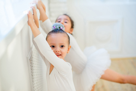 Two young ballet dancers learning the lesson. Try some new poseの写真素材