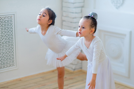 Two young ballet dancers learning the lesson. Try some new poseの写真素材