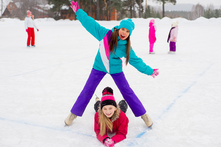 two attractive skater girls on the iceの写真素材