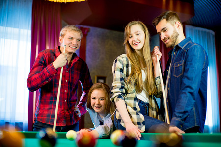 friends playing billiardの写真素材