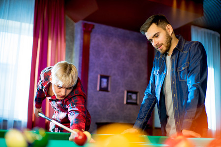 two men playing billiardの写真素材