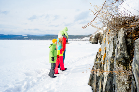 Family on a winter lakeの写真素材