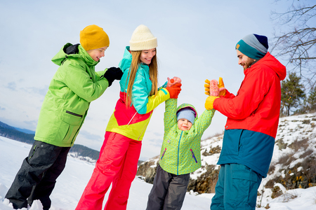 Family on a winter lakeの写真素材
