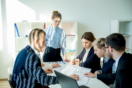 Buinesswoman with colleagues in office doing work